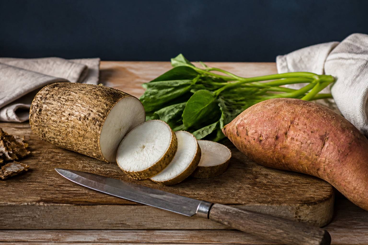 Ignames tranchées et patate douce sur une planche en bois